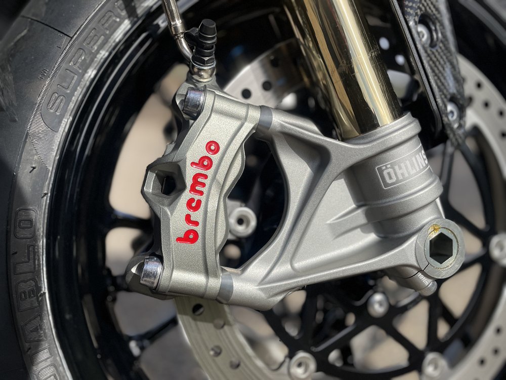 A close up view of the front caliper and disc brakes by Brembo on the Speed Triple 1200 RR.