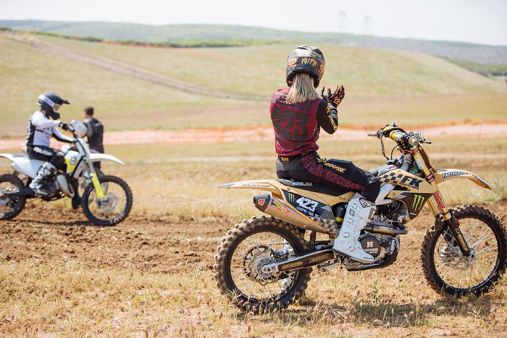 Vicki cheers on a student as they ride the motocross track