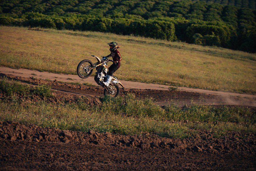 Pro motorcycle rider Vicki golden pops a wheelie on the motocross track