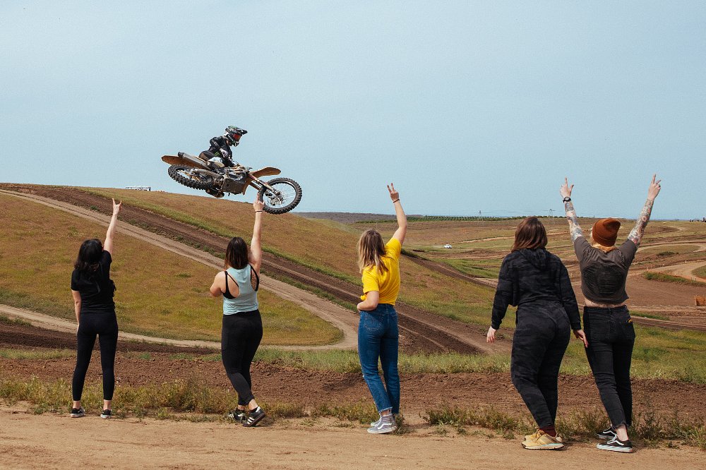 Pro femalle rider Vicki Golden jump whips her motorcycle over a jump