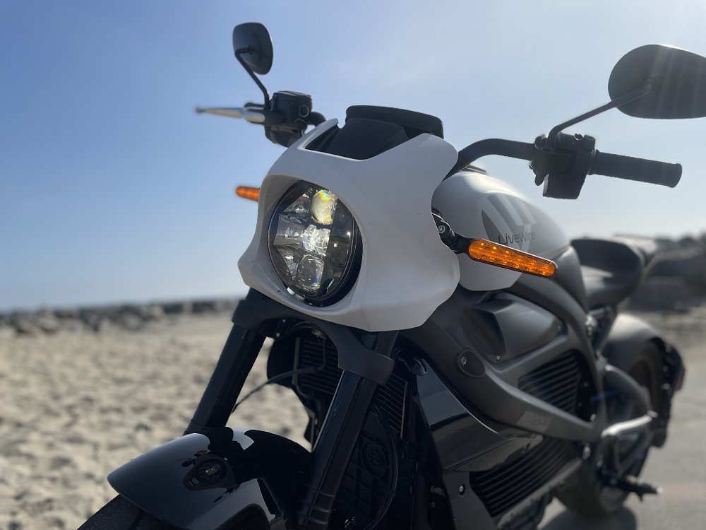 a close up of the livewire one headlight on a beach setting