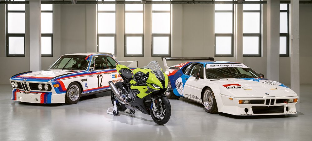 Motorcycle and two race cars