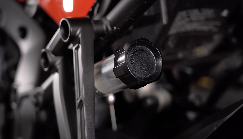Hydraulic shock preload adjuster on a motorcycle.