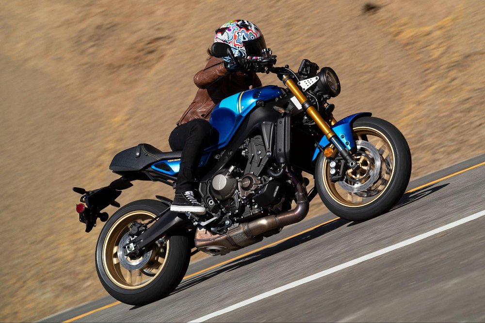 a female rider is banked over in a turn on board the xsr900