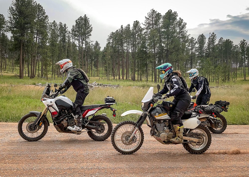 three riders on a dirt road