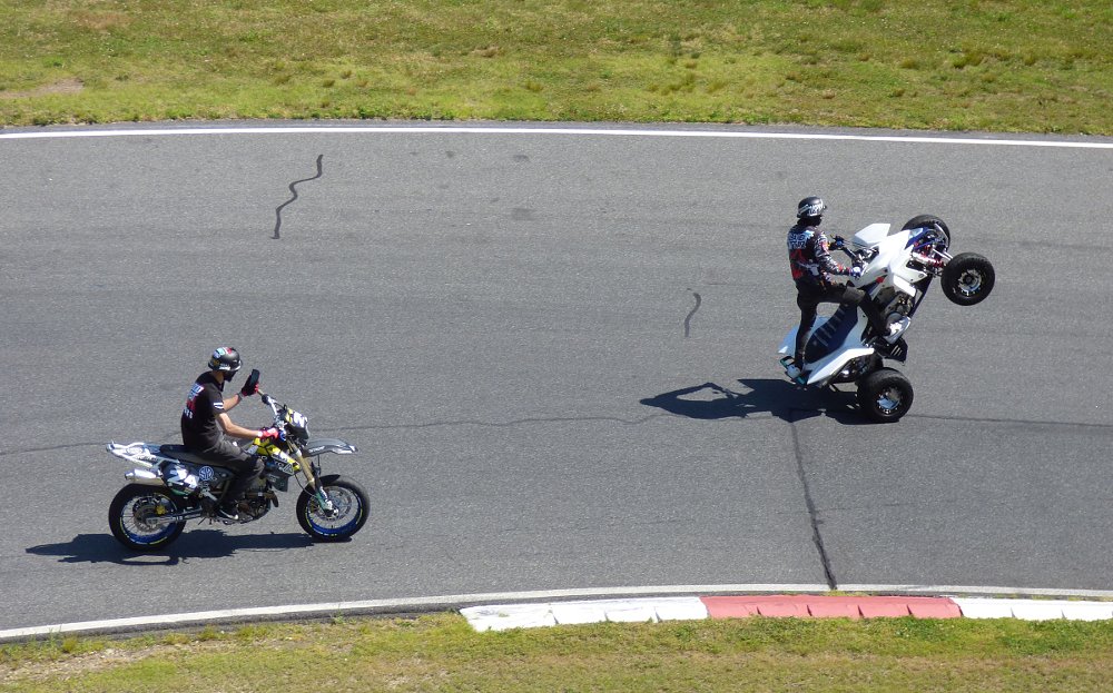 rider filming another rider on the track