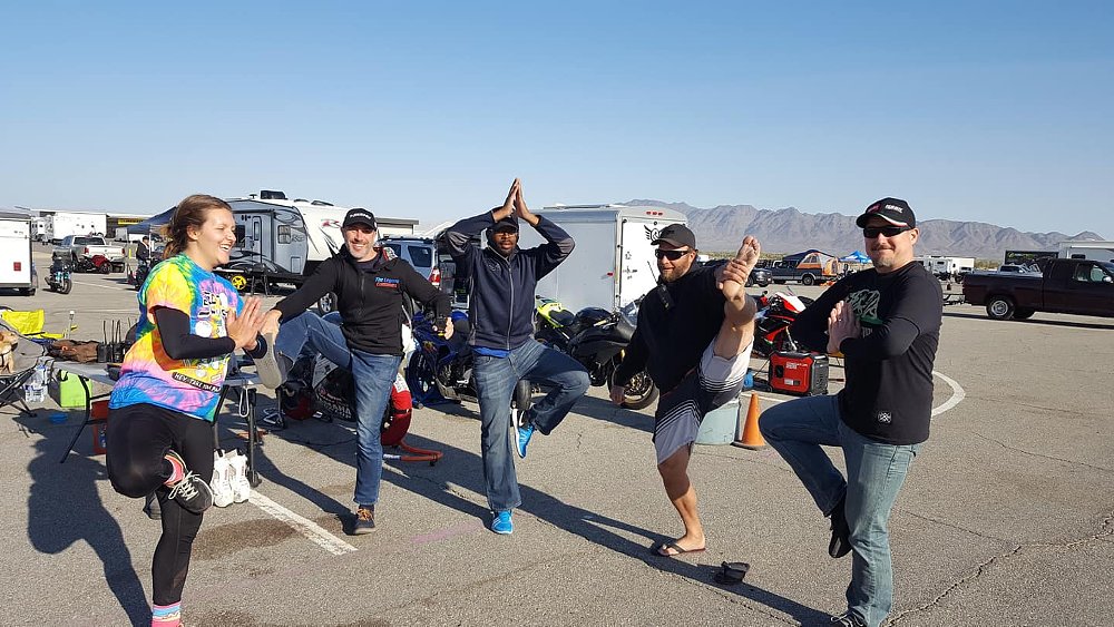 A group of flag marshals strike a yoga pose for fun