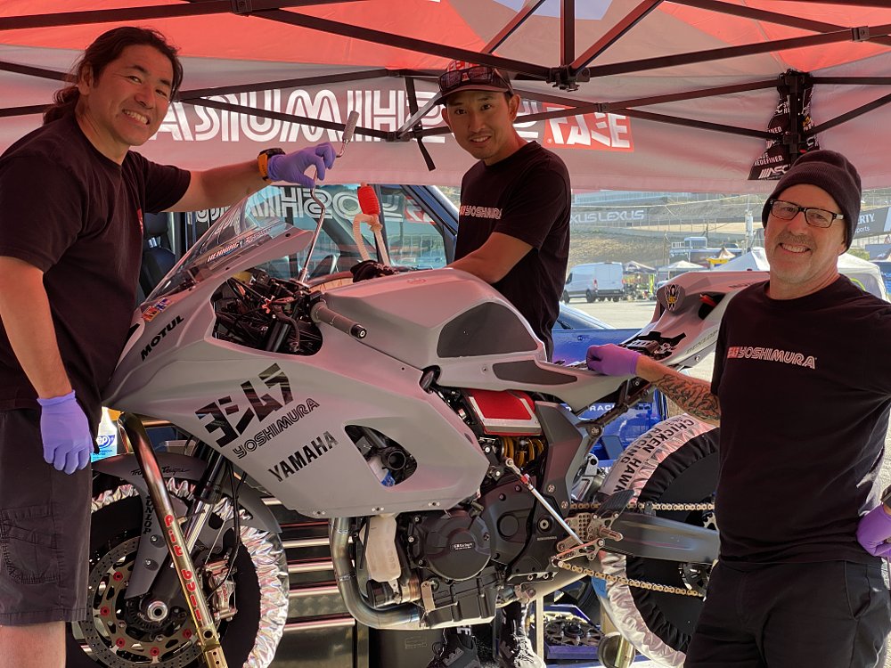 Daisuke Hashimoto, Yusaku Yoshimura, and Sean Storments work on the R7. 