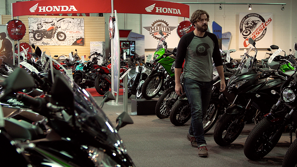 Spurgeon walks through a dealership full of new motorcycles