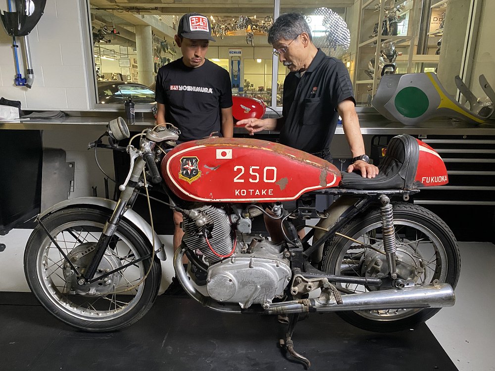 Pops Yoshimura's son and grandson with the Honda CB72 in the museum workshop