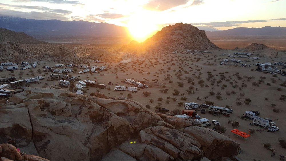 A high vista view of a desert riding area full of campers and RVs