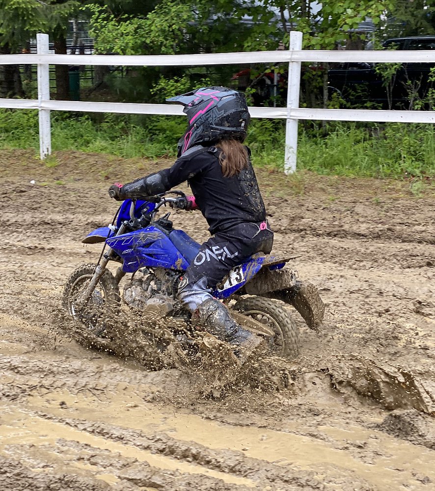 Gabbi on her minibike in axle-deep mud