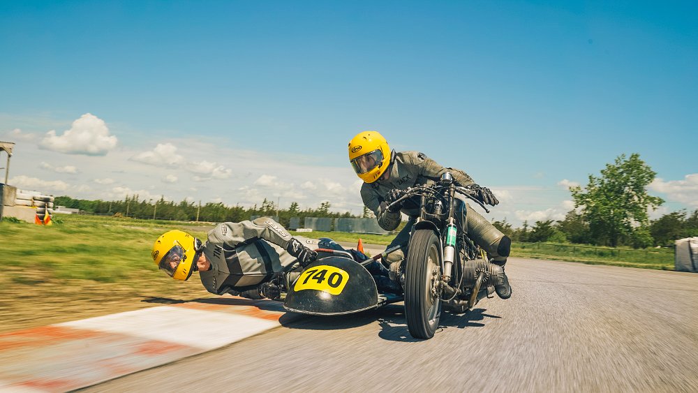 A vintage racing sidecar in action on track.