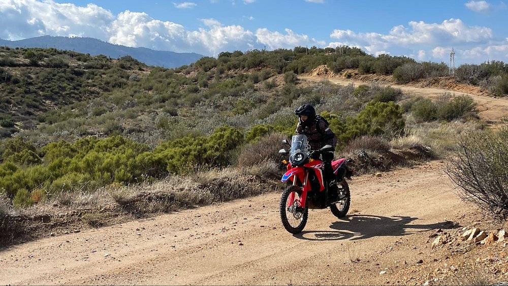 A far away view of female rider on the Honda crf300l rALLY