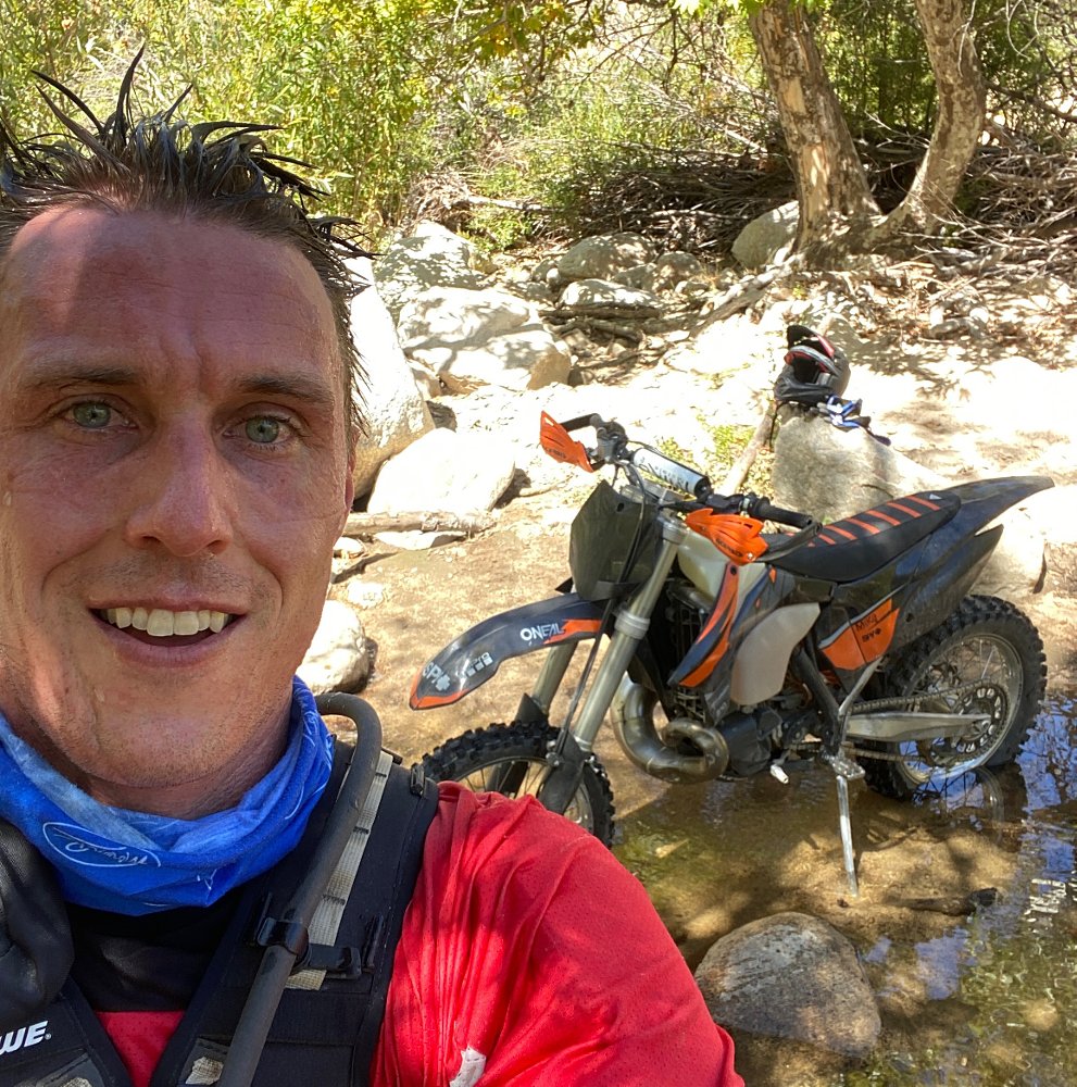 Ari in the woods with his motorcycle