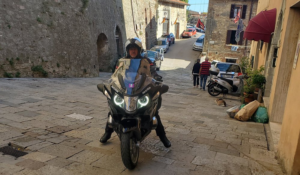 Peter on the BMW on a narrow, steep, cobblestone street