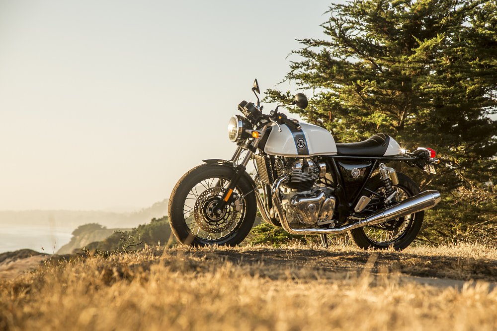 Royal Enfield Continental GT parked on a cliff overlooking the Pacific Ocean