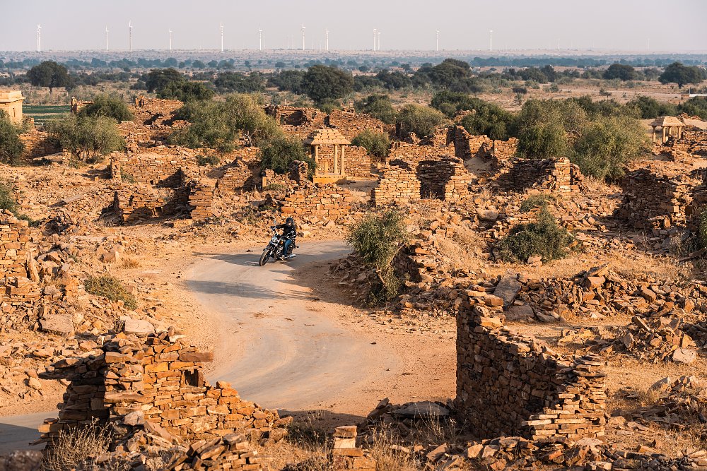 A action photo of female rider Jen riding through old Indian ruins