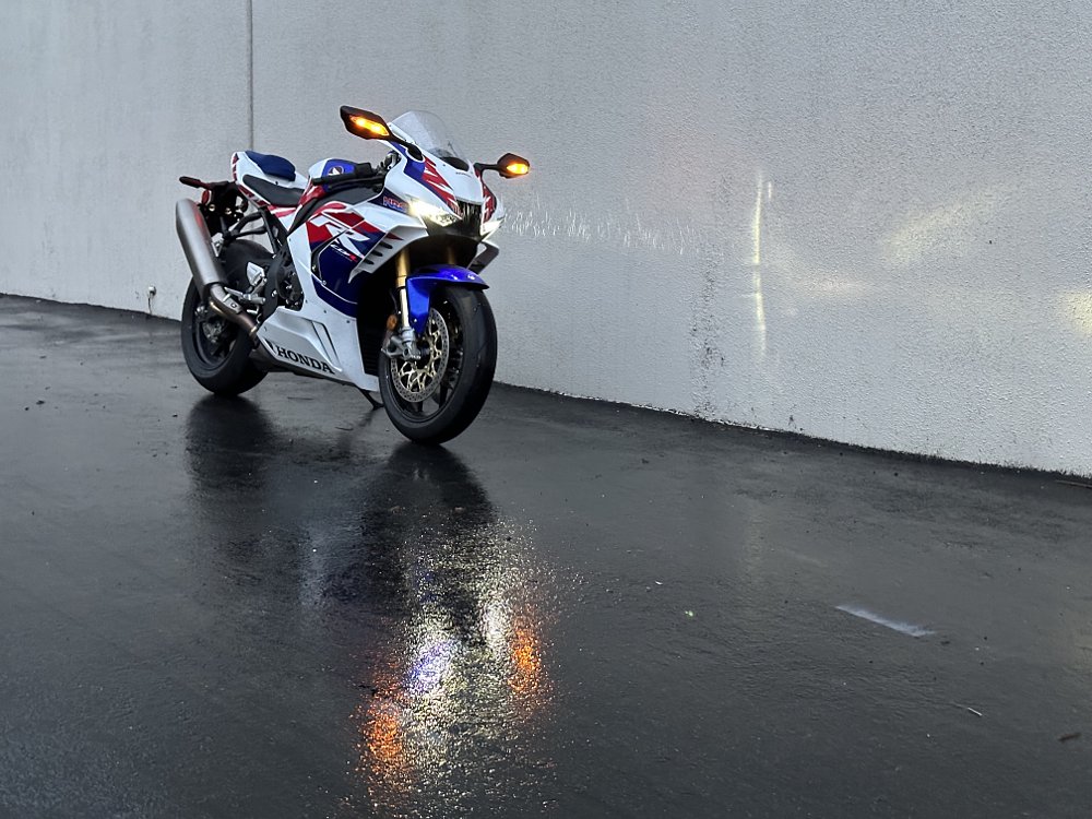 2022 Honda CBR1000RR-R SP front three quarter view, parked in the rain.