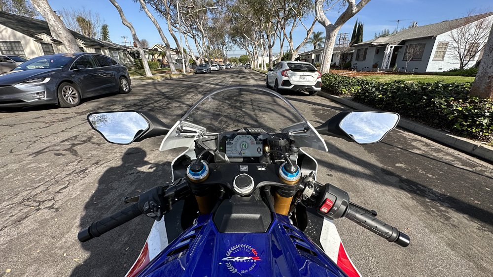 Honda CBR1000RR-R SP cockpit on a suburban street.