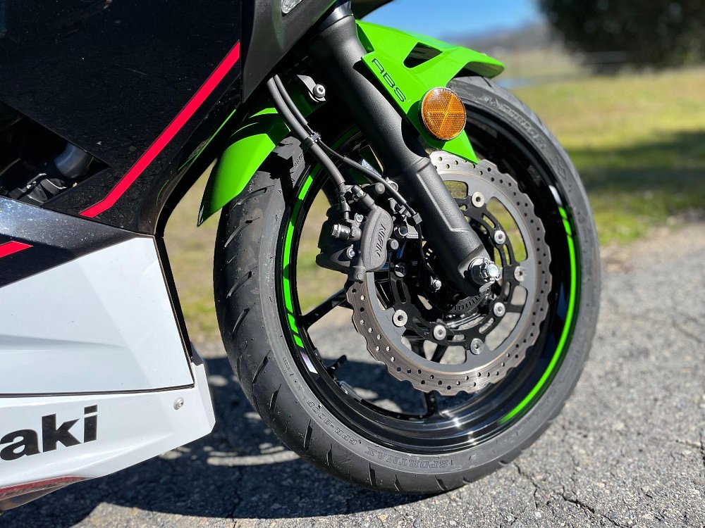 close up of the ninja 400 front wheel and disc brake