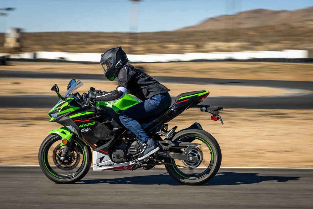 photo of a female rider on the ninja 400 going at speed in a straight away