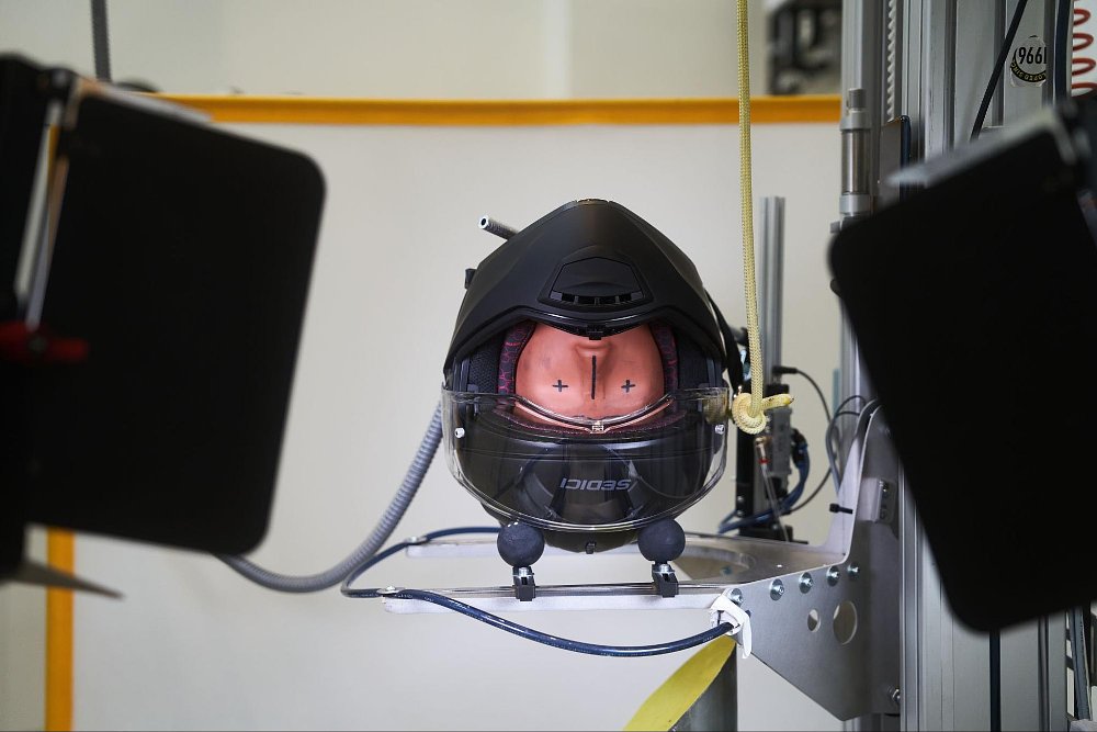 a photo of a motorcycle helmet in a testing facility