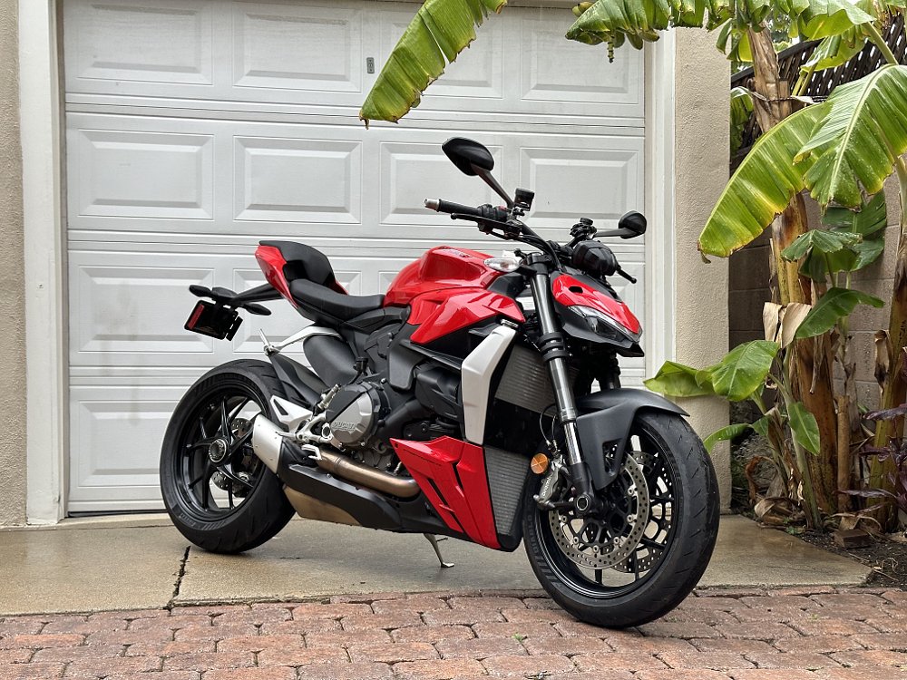 2023 Ducati Streetfighter V2 right side, in front of a garage door.