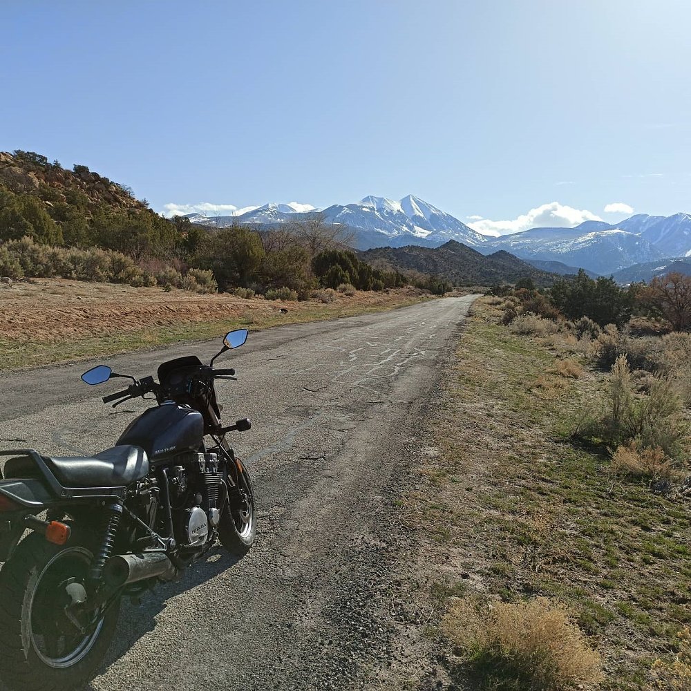 old Honda motorcycle parked on a remote road
