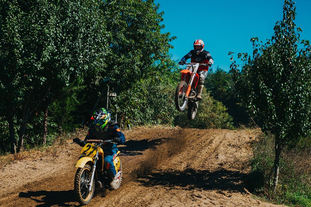 motocross bikes going over and landing from a jump