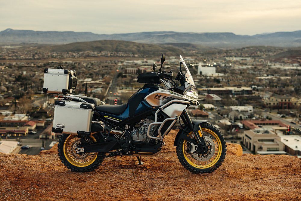 CFMOTO Ibex 800 T parked at an overlook with accessory aluminum panniers and top box