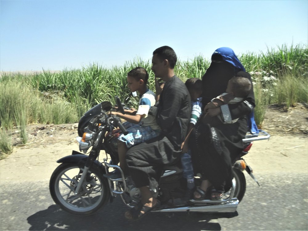 family of five on a small motorcycle