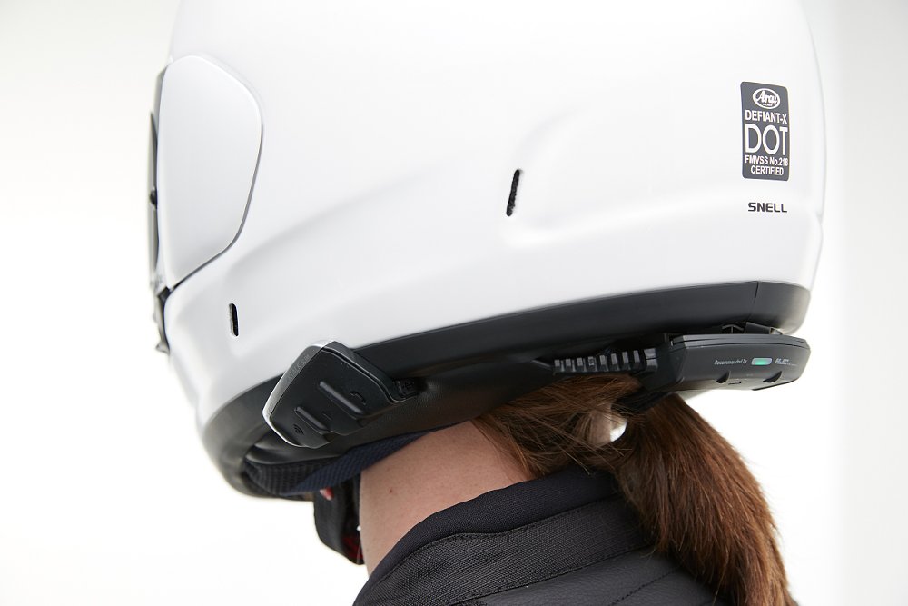 woman wearing helmet with a Cardo Bluetooth communicator