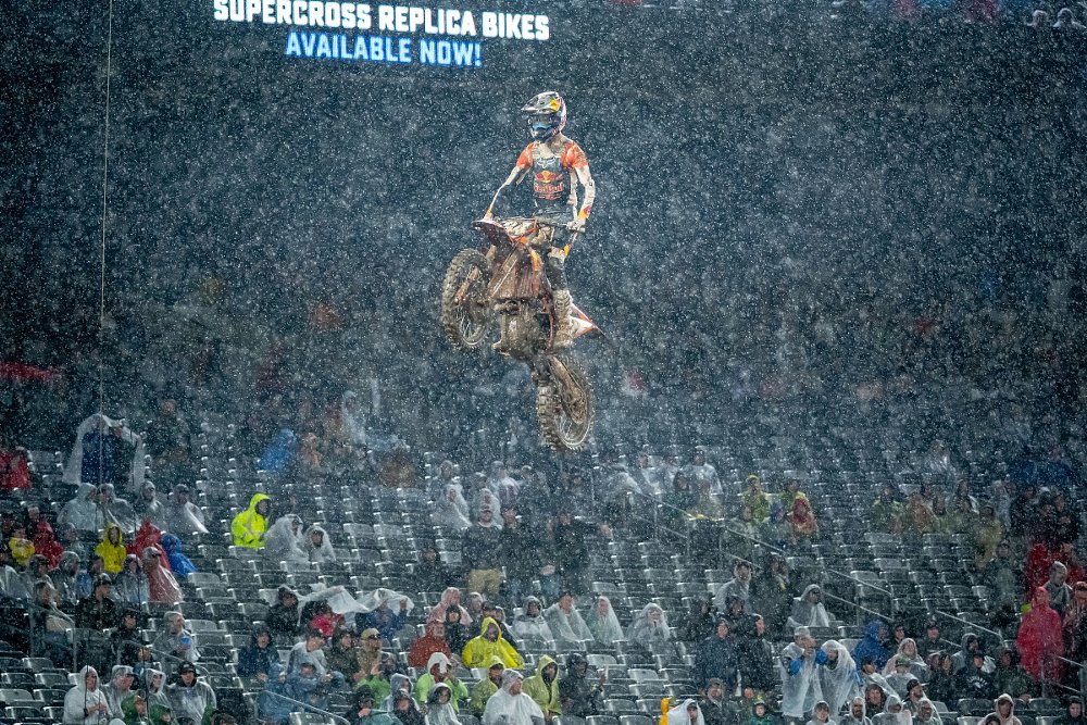mud-covered motocross racer in the rain