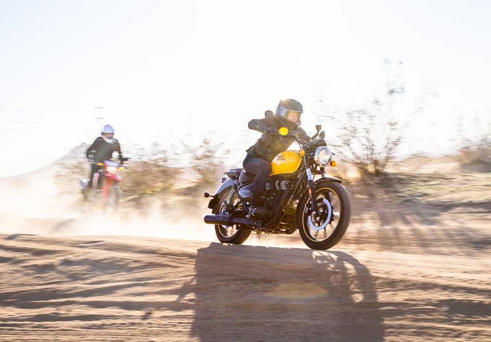 A Royal Enfield Meteor 350 riding on a dirt road.