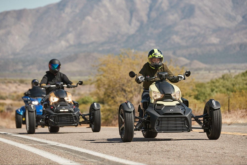 two ryker riders going down a straight road