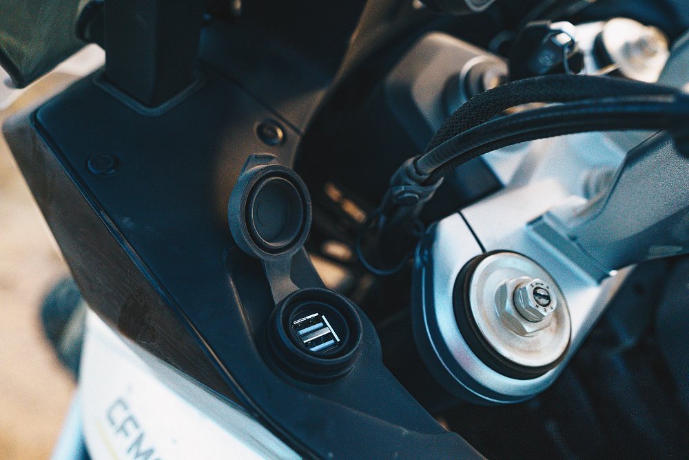 A detail image of USB ports in the CFMOTO Ibex 800's cockpit.