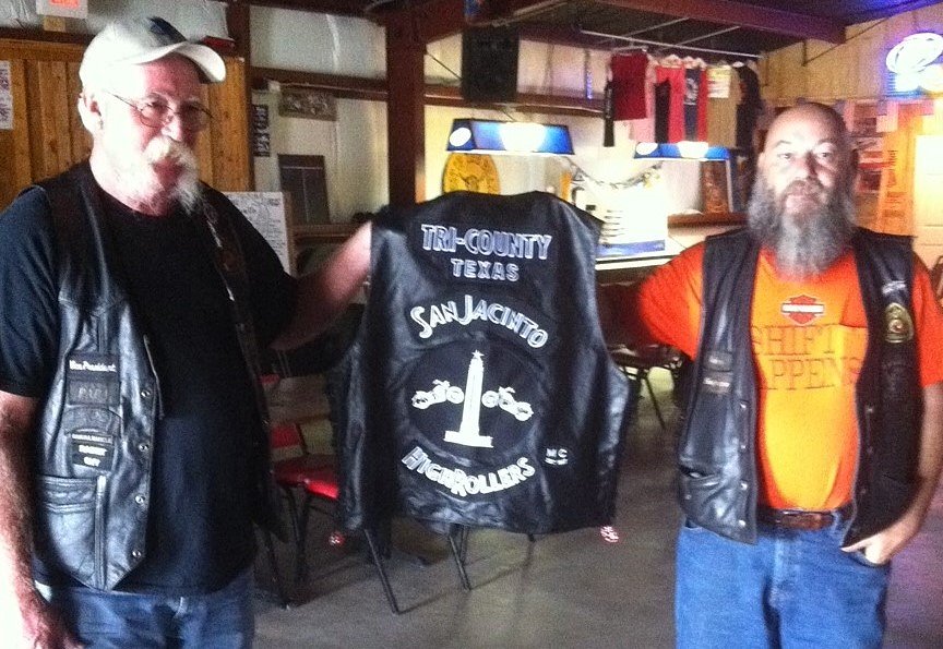 club officers showing off a vest