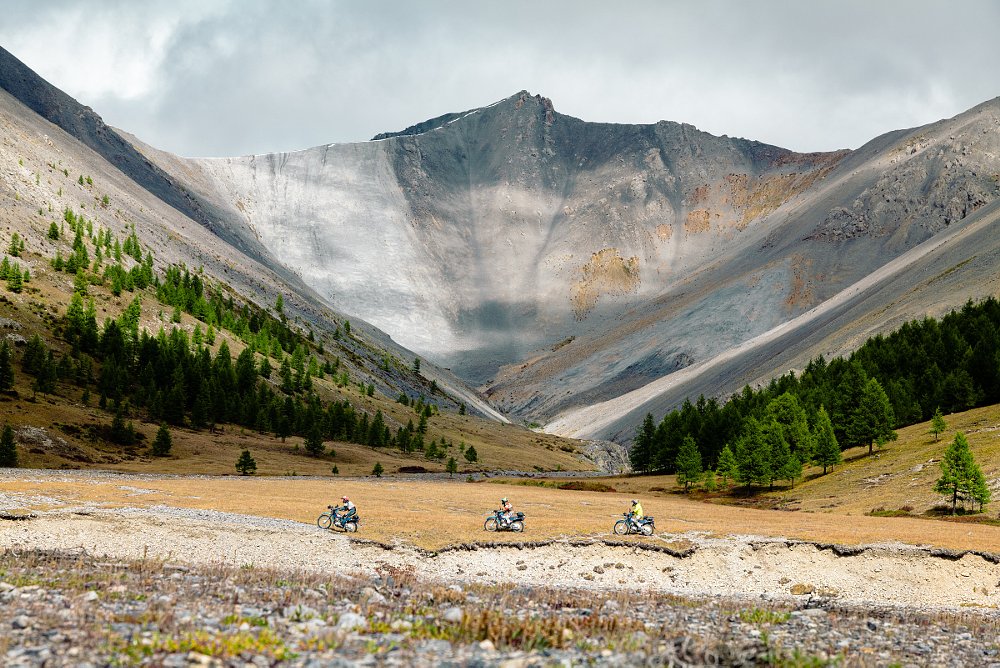 motorcycles riding in front of mountains in Mongolia