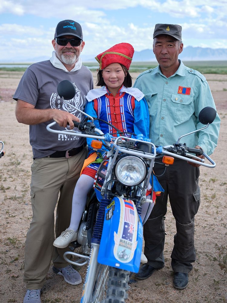 Tom Medema, a ranger, and his daughter sitting on the motorcycle
