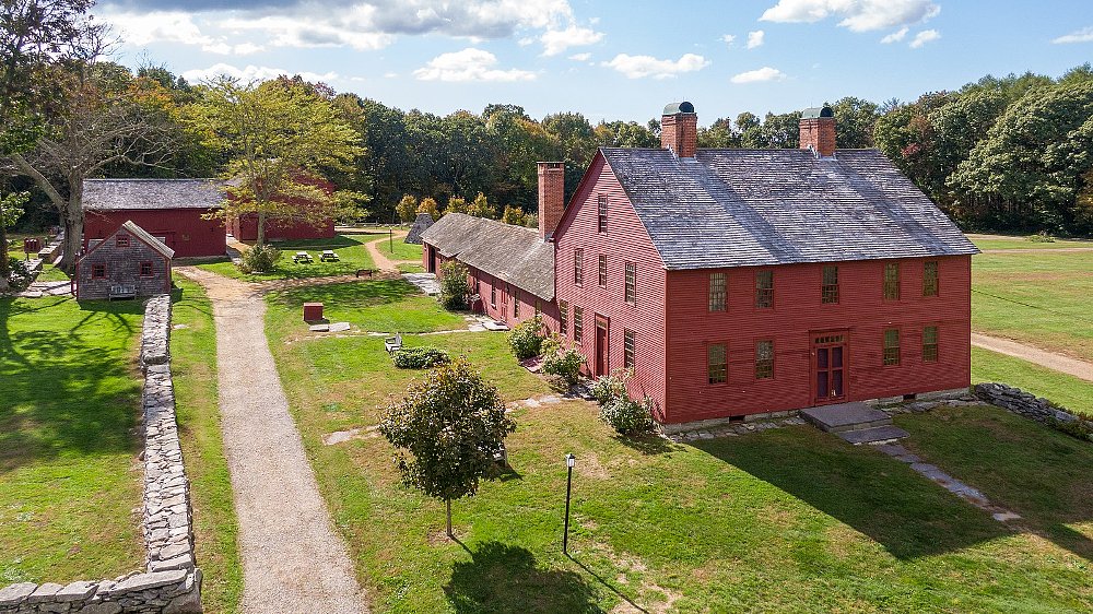 A photo of the Hale estate, with changing color leaves in the fall and a big red barn and house in a field
