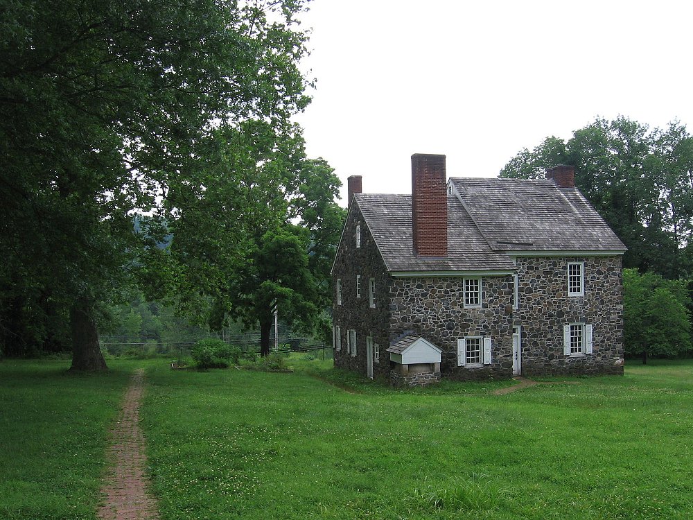 The house depicted here is made of stone and has unique double slanted roof. this house george washington planned war stratgies in