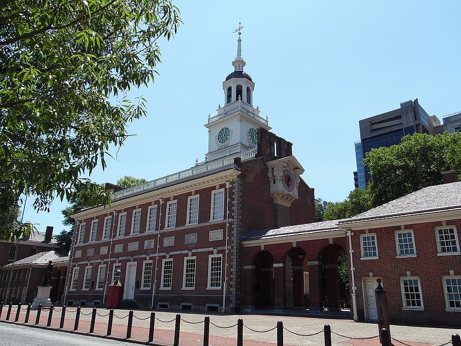 an upward angle shot of the brick building Independence Hall in downtown Philadelphia