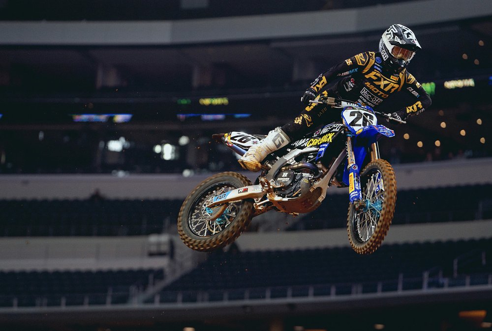 Supercross racer Alex Martin on a blue yamaha sailing through the air on a big jump