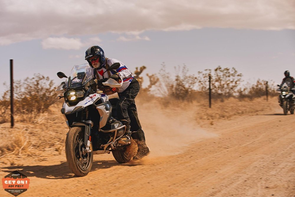 a instructor mounts the motorcycle while it is moving in the Mojave Desert