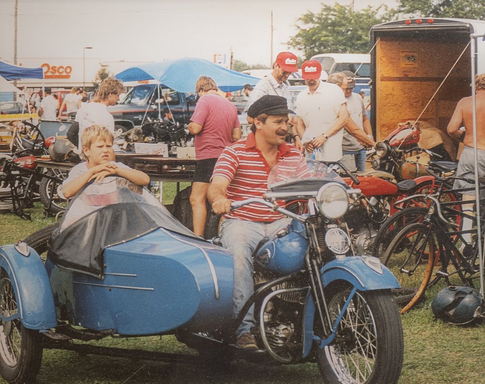Young Matt and Dale Walksler riding a motorcycle and sidecar