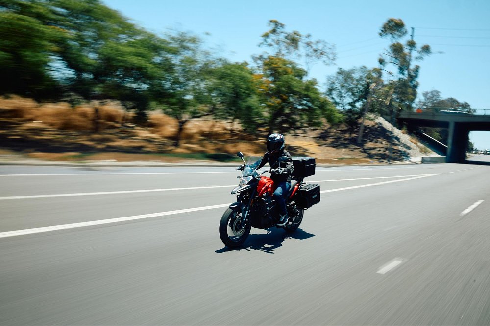 a front view of the RX1E riding on the highway with motion blur at speed