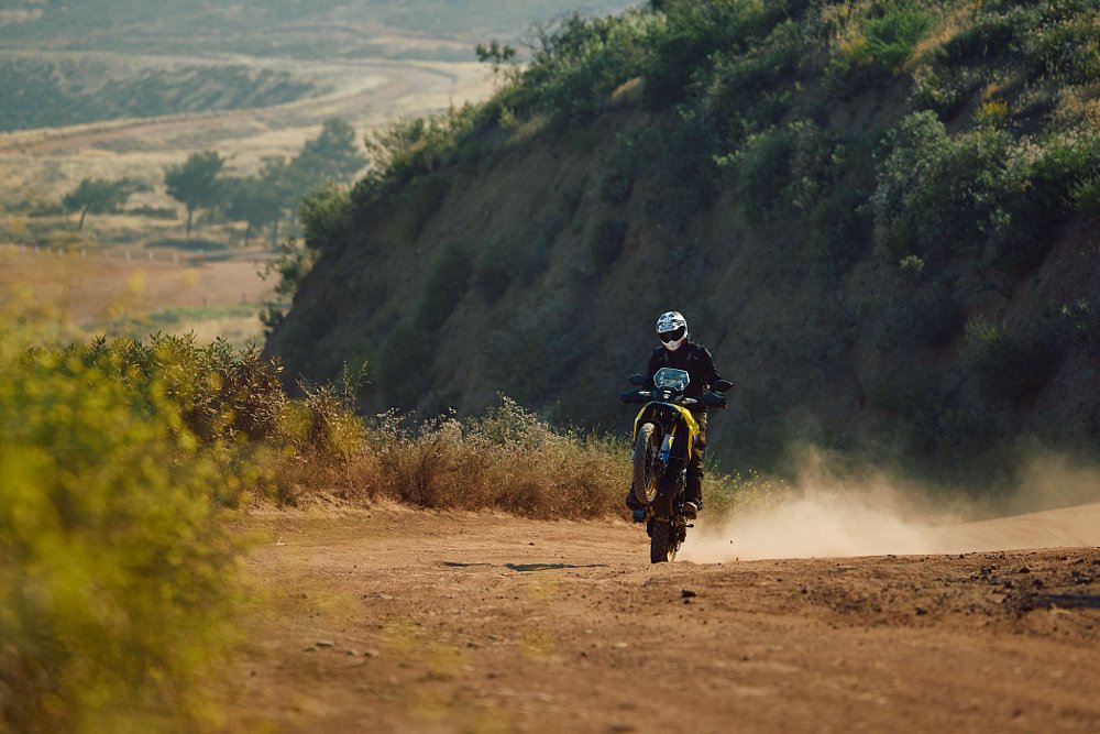 V-Strom 800DE doing a wheelie on a dirt trail