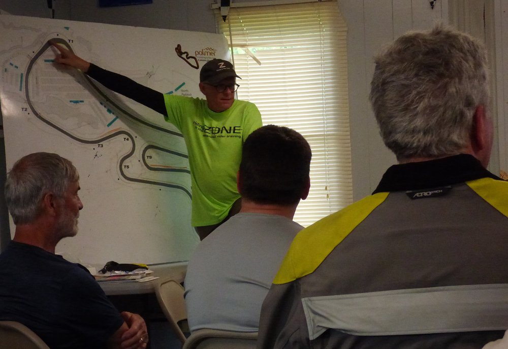 Ken Condon points to a track map during a classroom session