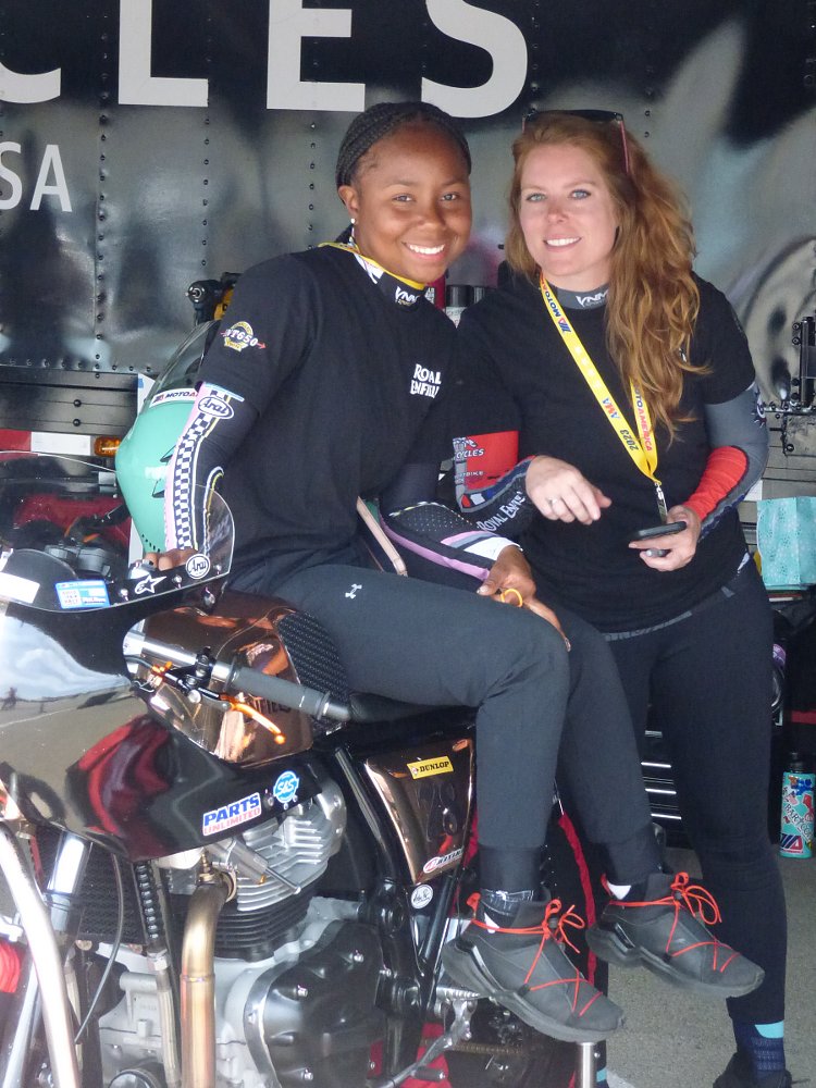 Mikayla Moore and fellow rider sharing a laugh in the race paddock